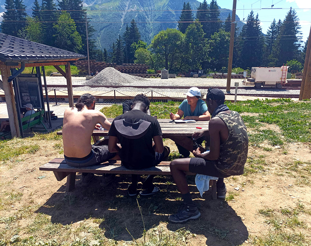 Des jeunes suivis par la Protection judiciaire de la jeunesse réunis après le petit-déjeuner avant de reprendre une randonnée dans les Alpes.